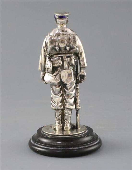 A late Victorian novelty silver and enamel inkwell, modelled as a sailor from HMS Duke of Wellington, overall 17cm.